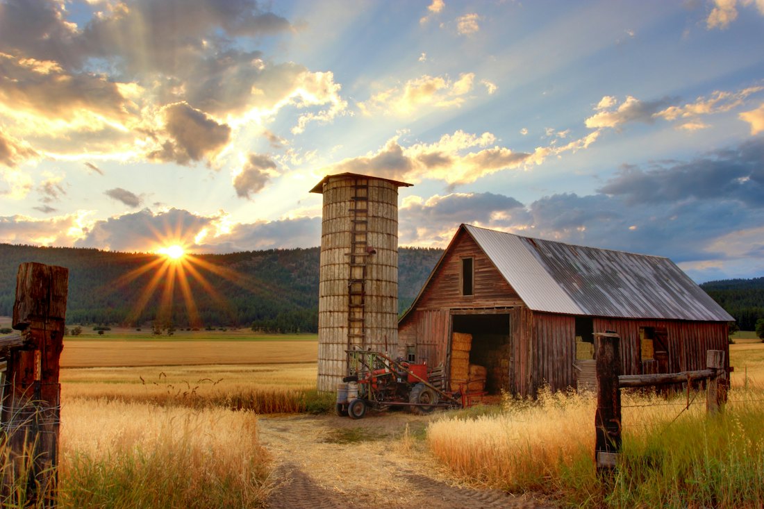 Old barn and silo at sunset